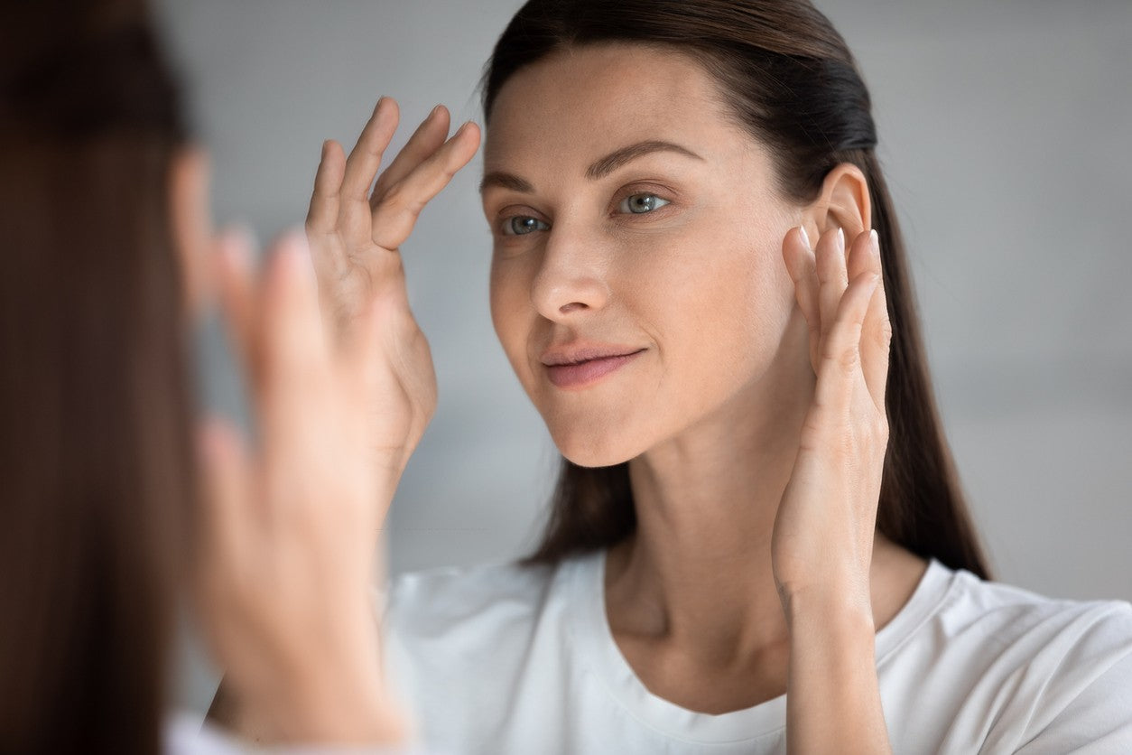woman-admiring-skin-in-mirror