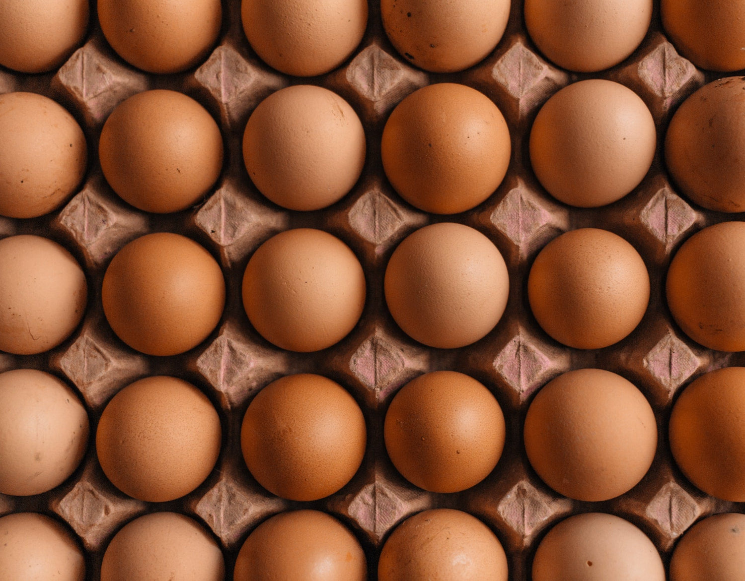 It's a picture of at least thirty brown eggs.