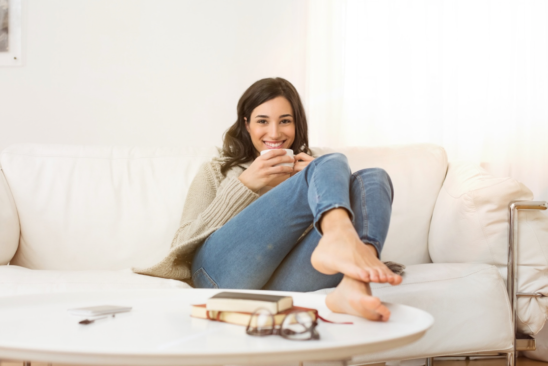 Woman relaxing in colder weather fall with coffee and a great new skincare routine