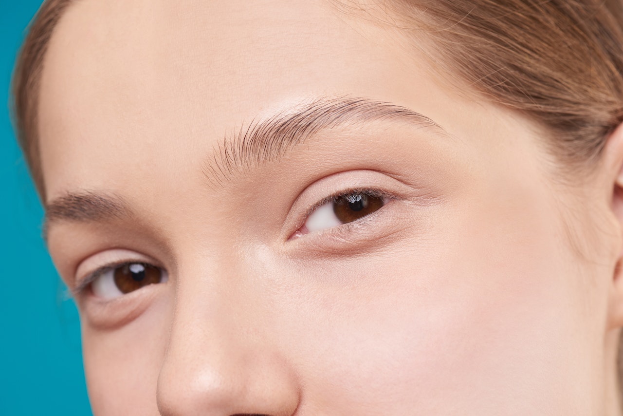 A close up of a woman's brown eyes and nose as she looks in the camera.